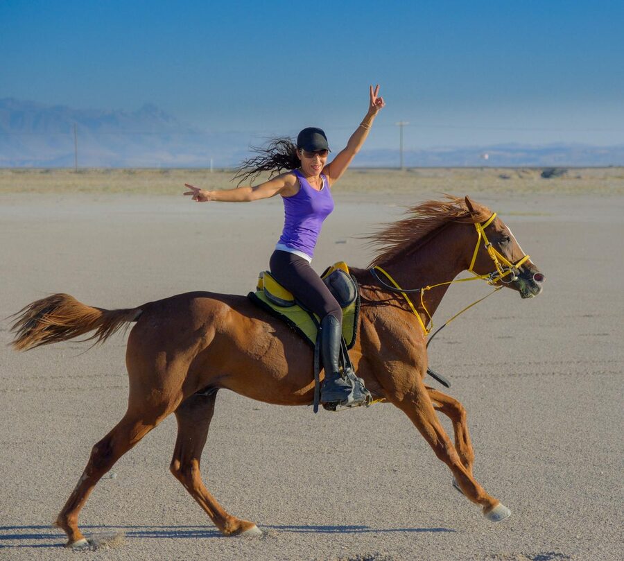 Rider galloping through open desert terrain on horseback