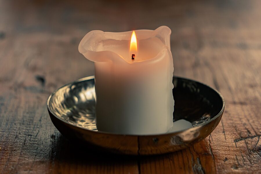 Warm candlelight on a wooden surface creating an intimate mood
