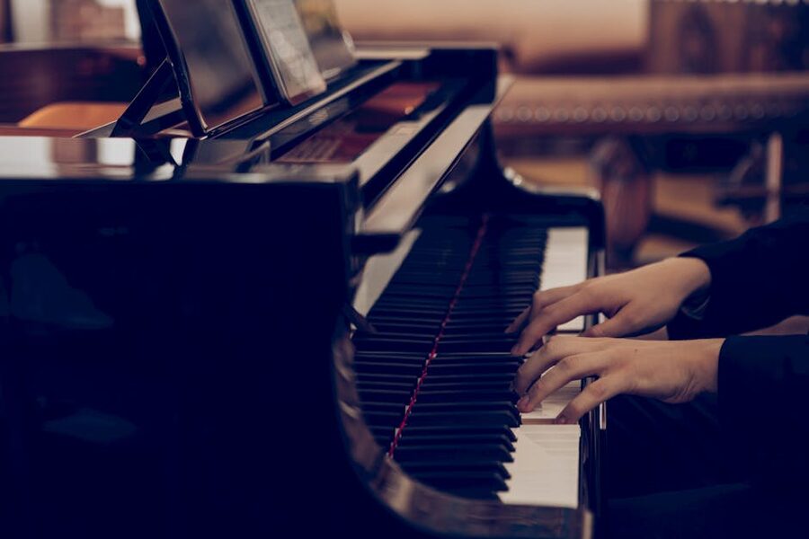 Pianist hands on piano keys during a performance