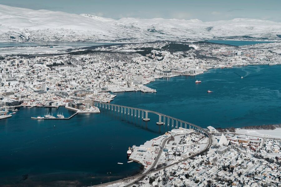 Aerial view of snowy Tromso with iconic bridge