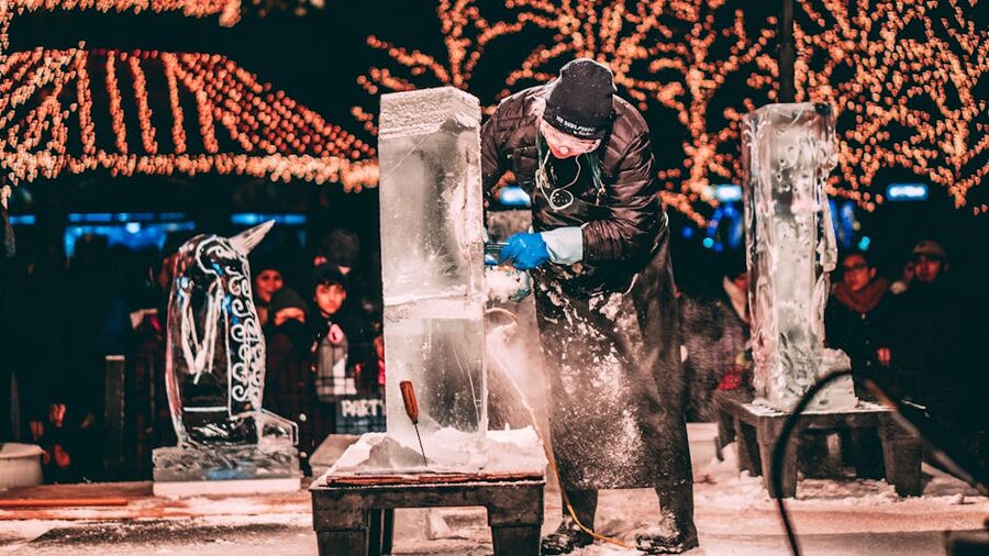 Artist carving ice sculpture at festival