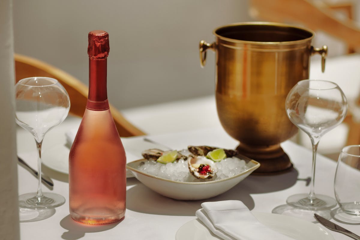 Elegant dining table set with wine glasses, bread, and French cuisine