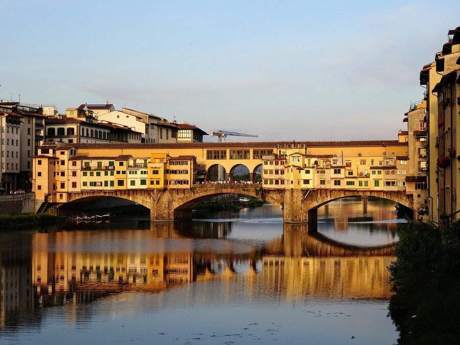Historic Ponte Vecchio bridge with shops built along it spanning the Arno River