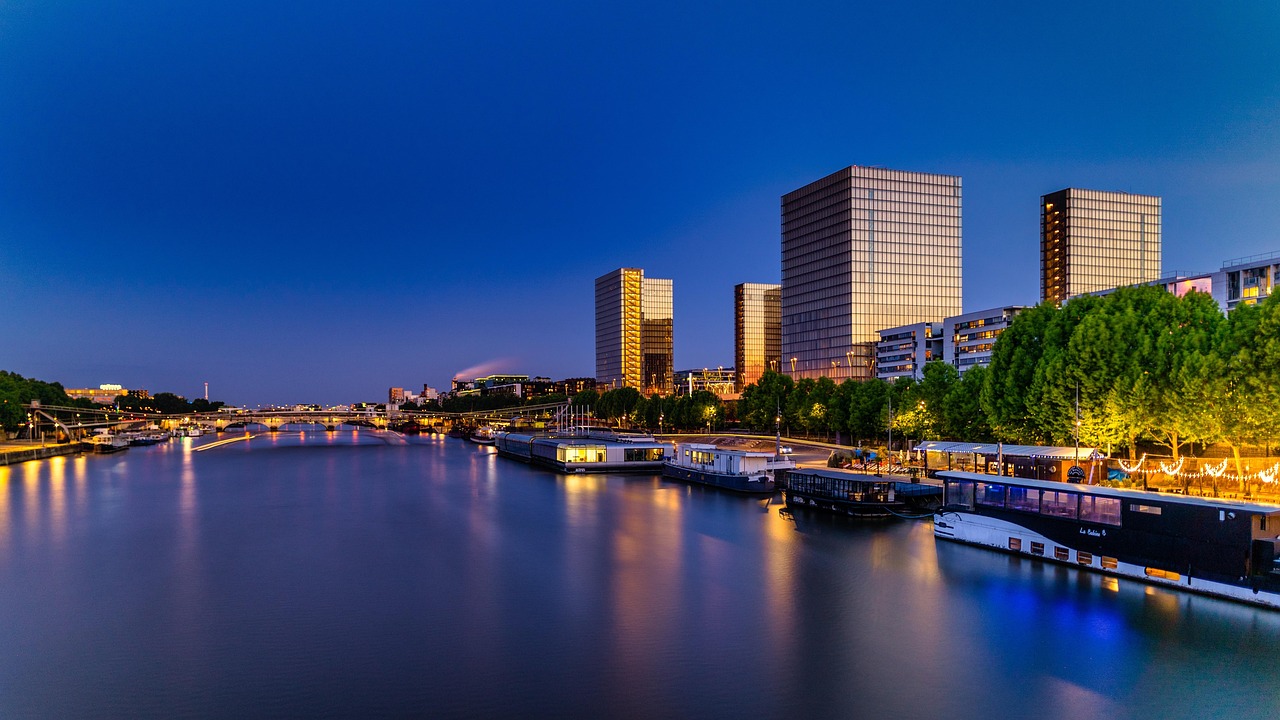 Paris at night from the Seine River with illuminated bridges and reflections