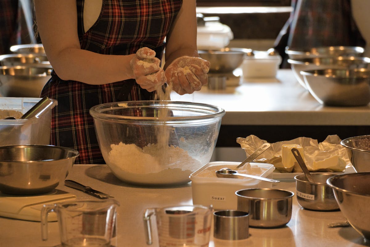 Close-up of woman mixing ingredients in a bowl during a baking class