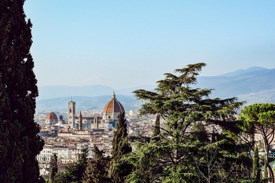 Florence Duomo cathedral dome rising above rows of terracotta-colored rooftops