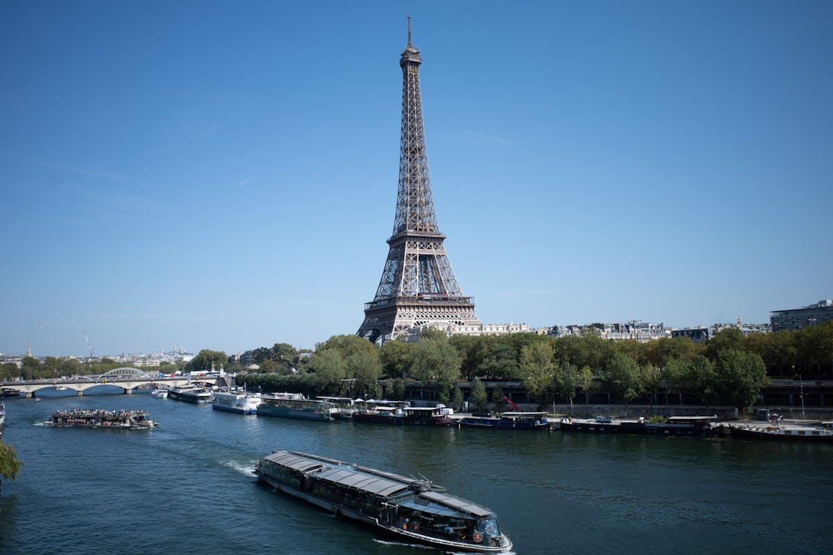 Ferries and boats on the Seine River in Paris near the Eiffel Tower