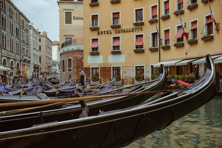 Gondolas moored along a Venice canal with historic buildings