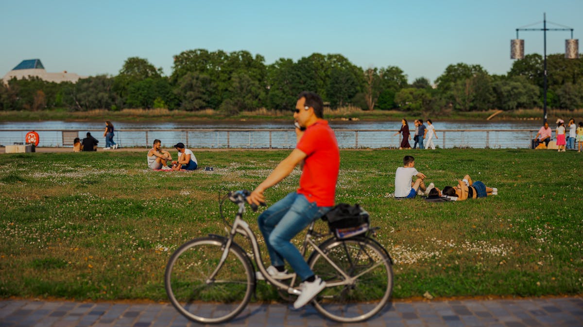 People relaxing and cycling by the riverside in Bordeaux France