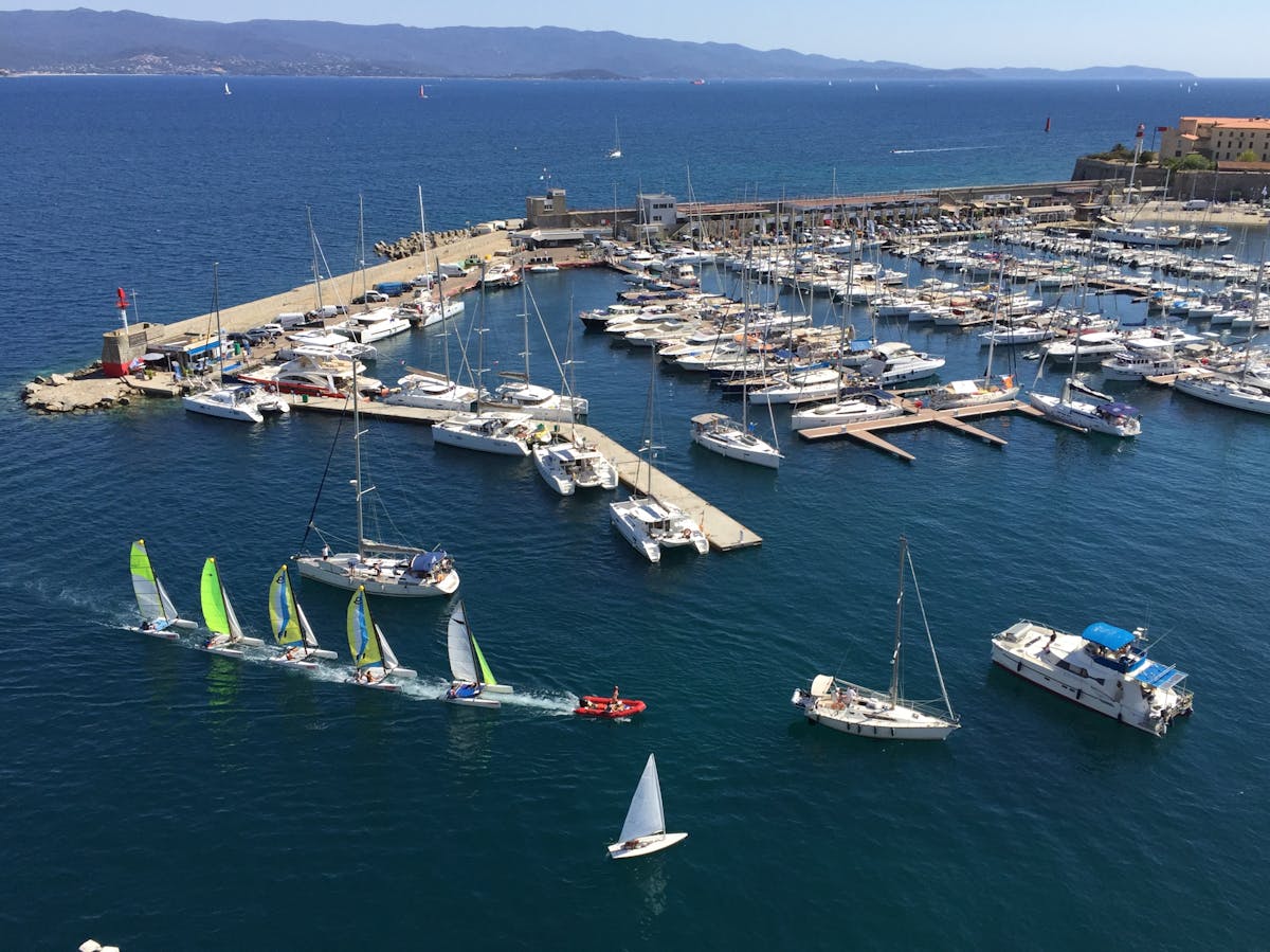 Aerial view of Ajaccio port with sailboats and the town behind