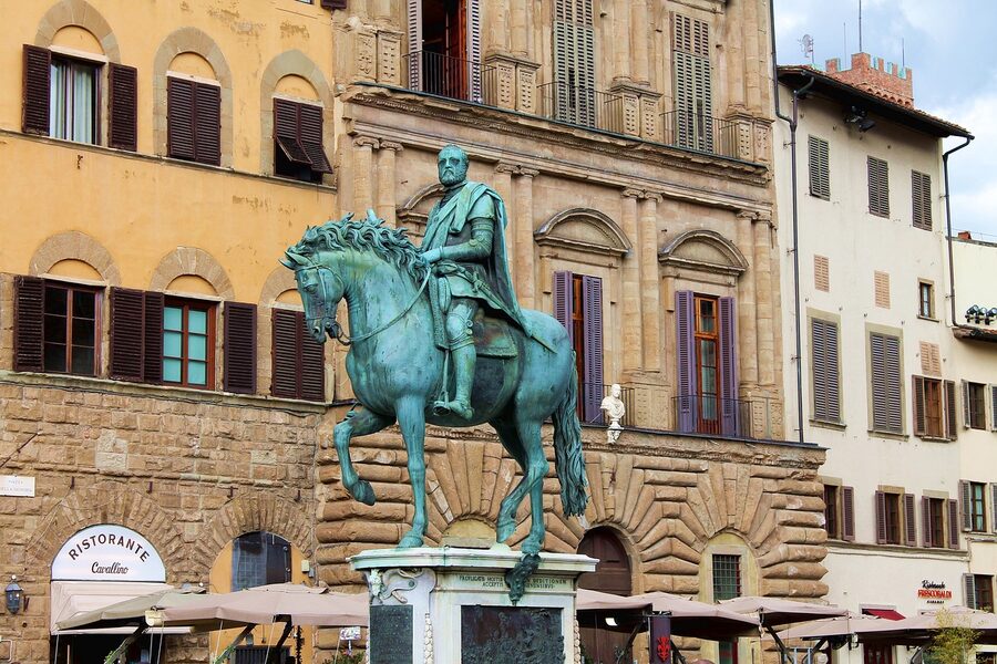 Bronze equestrian statue of Cosimo I in Piazza della Signoria with Palazzo Vecchio tower