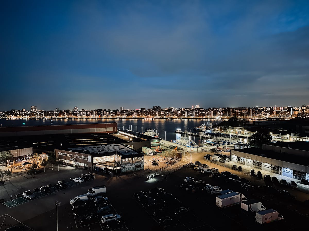 Dazzling night cityscape of Amsterdam overlooking waterfront and urban lights