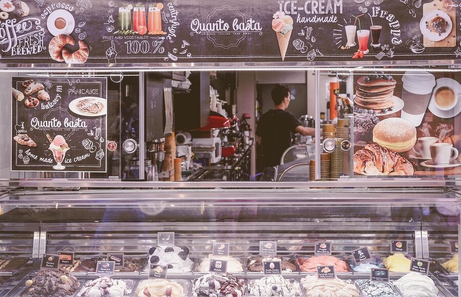 Gelato shop display case showing rows of colorful gelato flavors