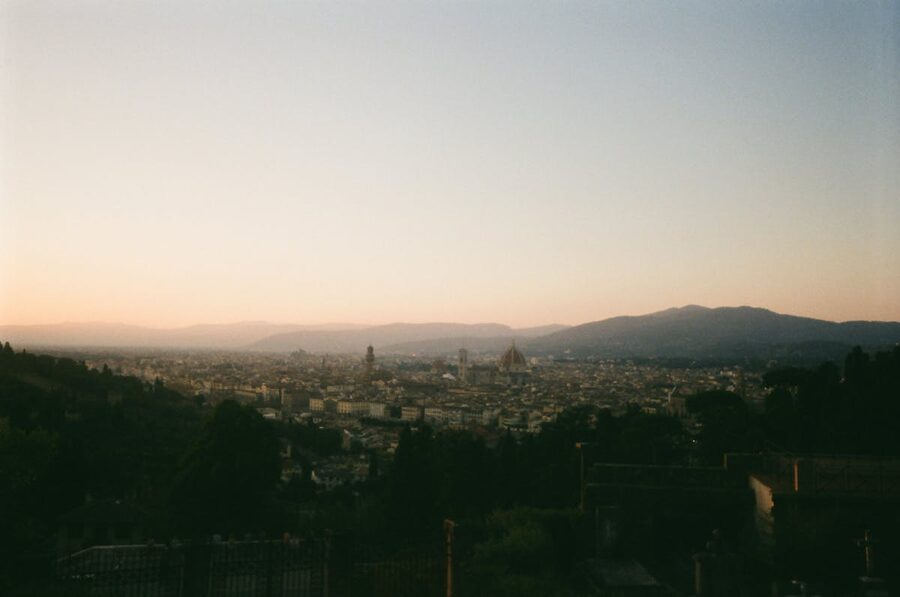 Florence skyline at sunset with dramatic orange and purple sky over the city