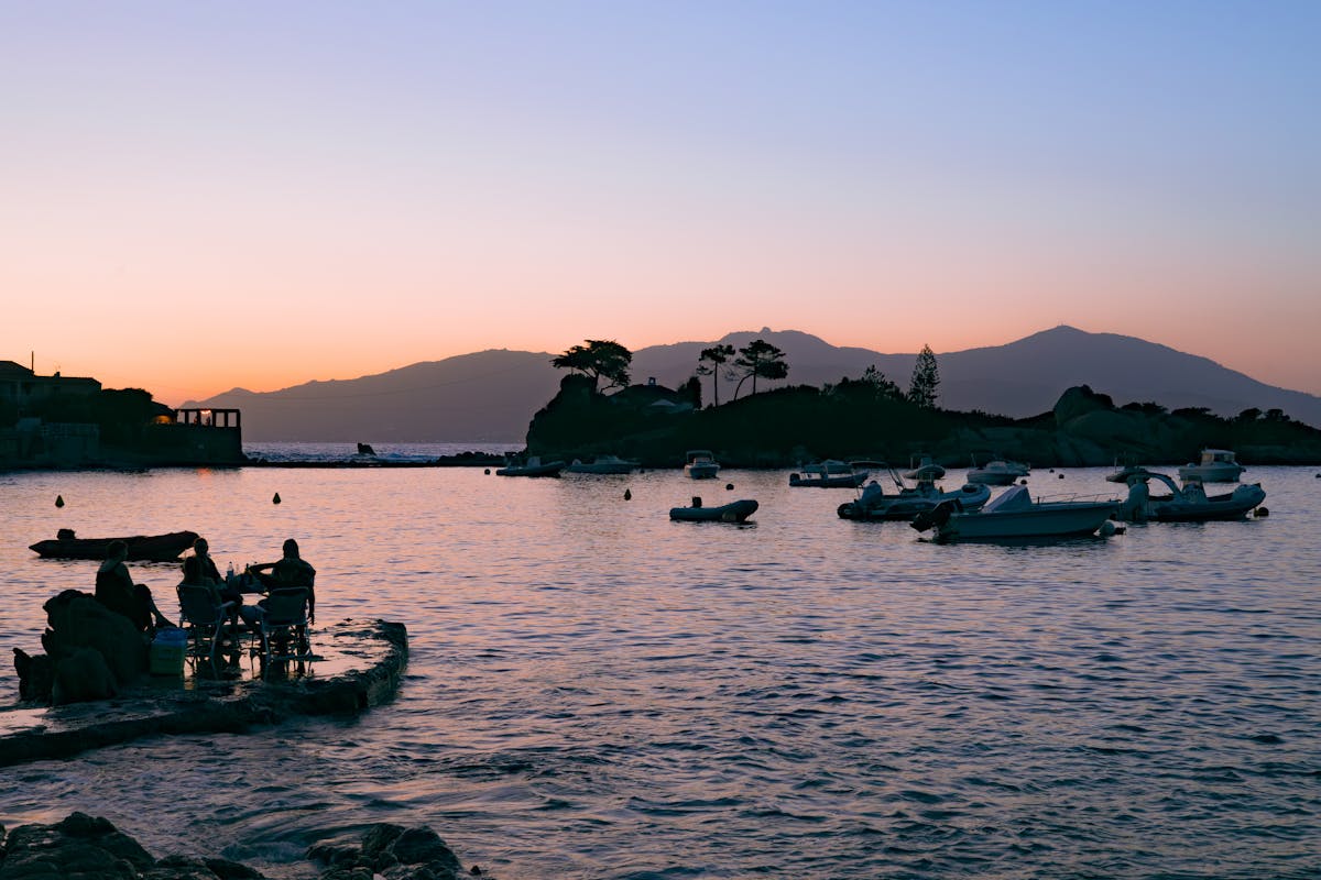 Ajaccio coast with boats and silhouettes during sunset