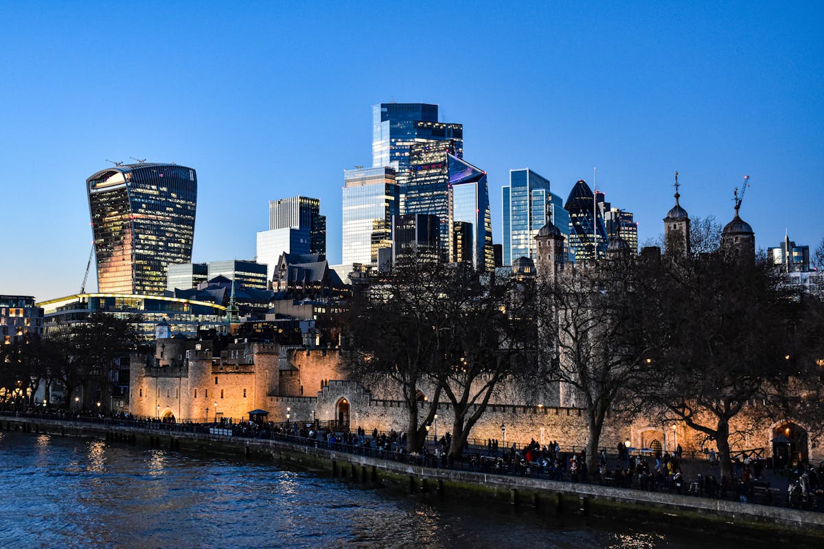 Iconic London skyline featuring Tower of London and modern skyscrapers at dusk