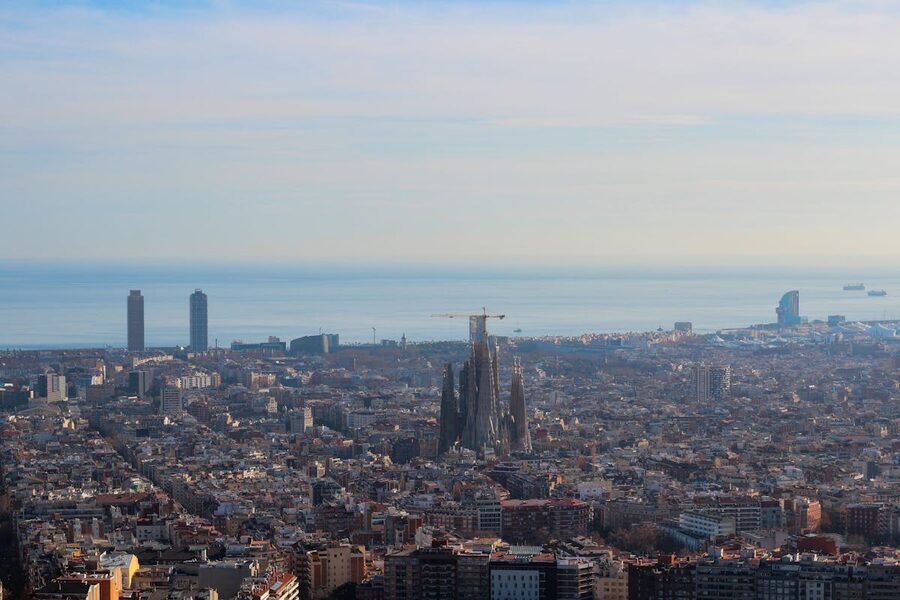 Aerial cityscape of Barcelona with Sagrada Familia and coastline