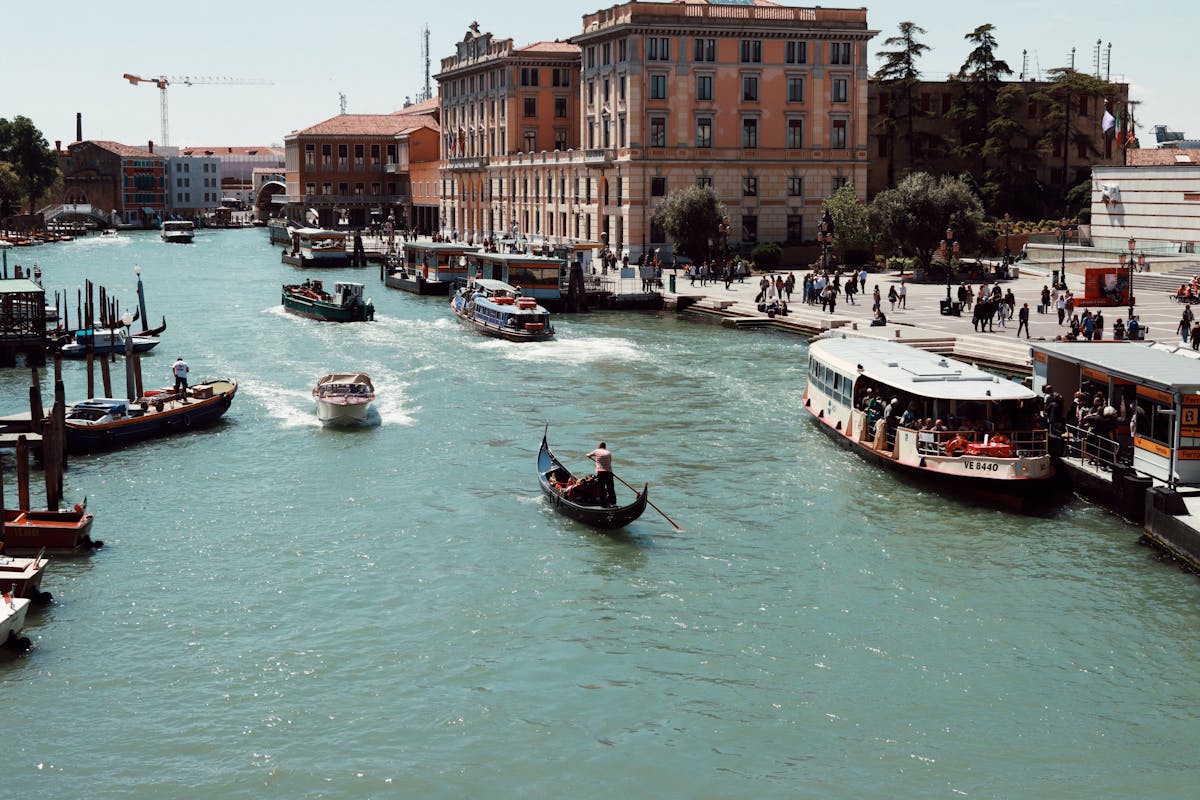 Grand Canal in Venice with gondolas and boats against historic architecture