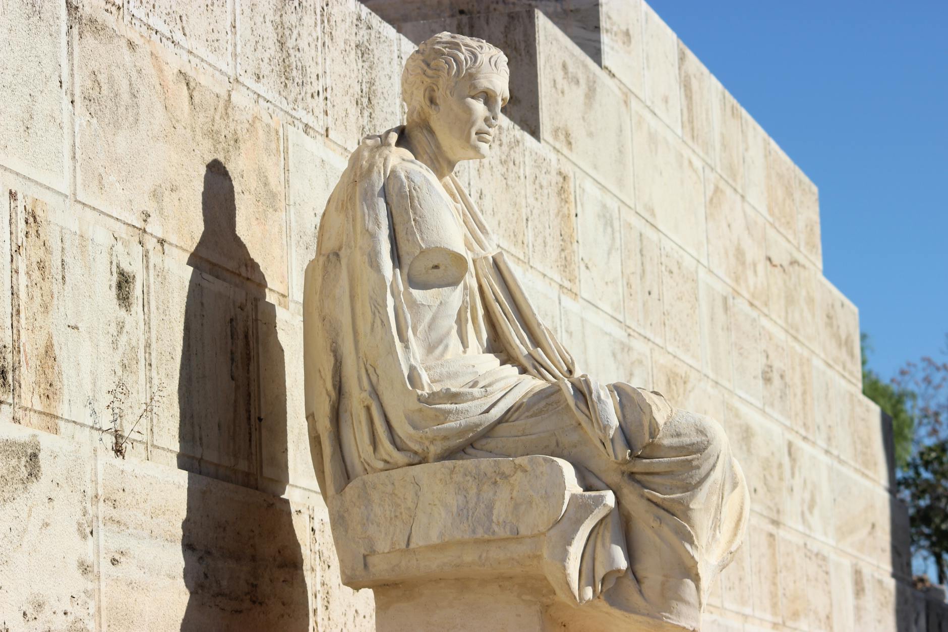 Seated stone sculpture from ancient Greece in Athens captured in natural light