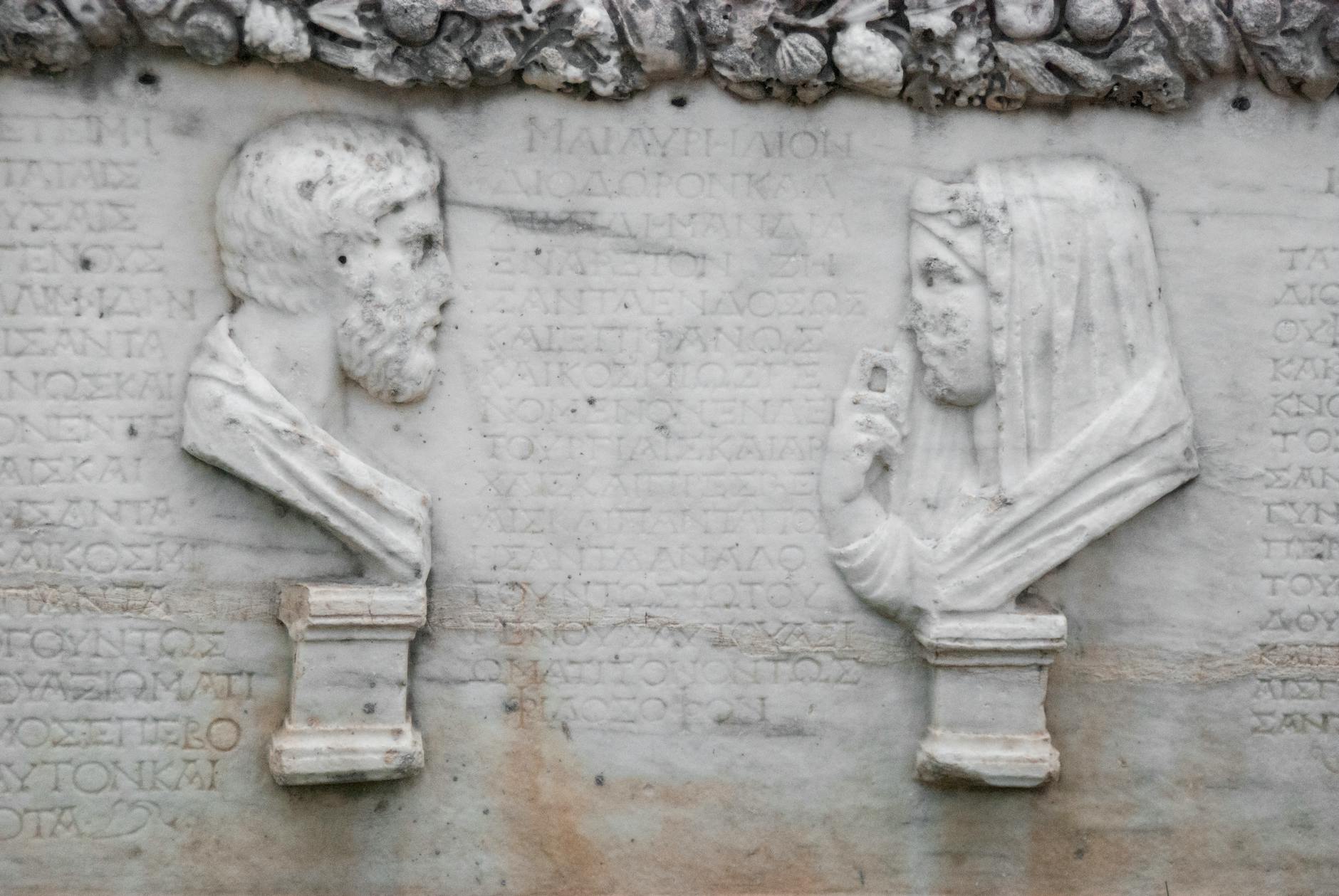 Ancient Greek marble relief sculpture with two figures in profile