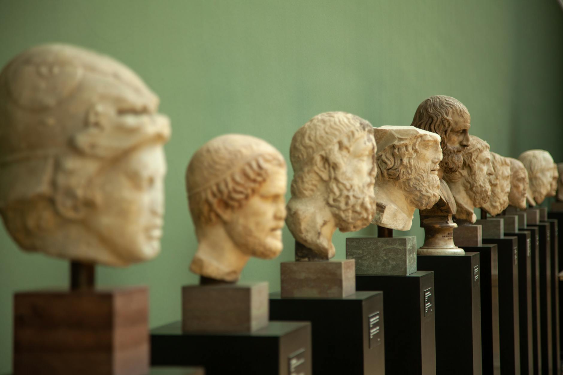 Ancient sculptures displayed in a museum gallery setting