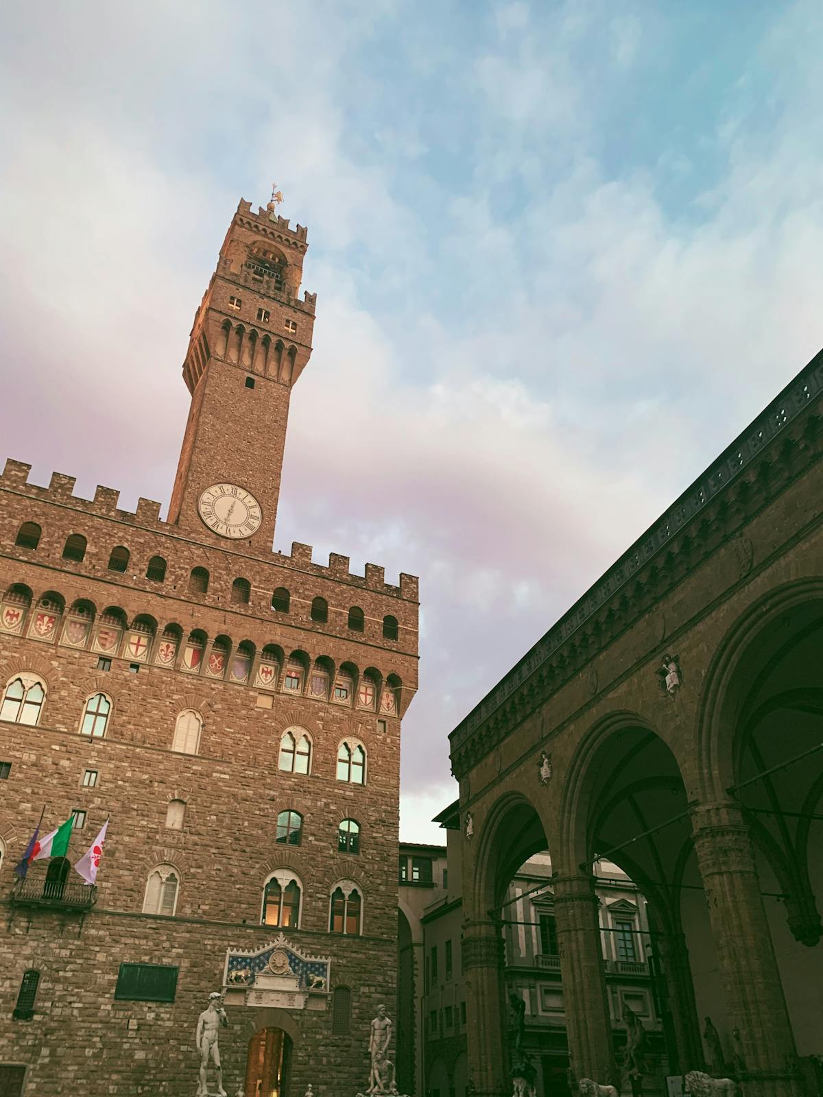 The imposing facade of Palazzo Vecchio rising above Piazza della Signoria in Florence Italy