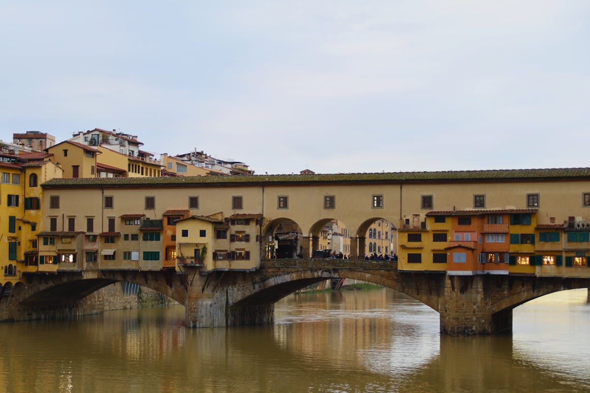 Historic Ponte Vecchio in Florence Italy captured at dusk with serene river reflection