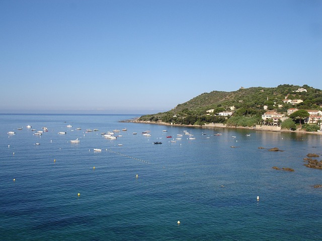Ajaccio harbour with boats moored and Corsican mountains in summer