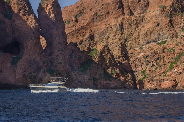 Dramatic red volcanic rock formations of the Scandola Nature Reserve meeting the sea