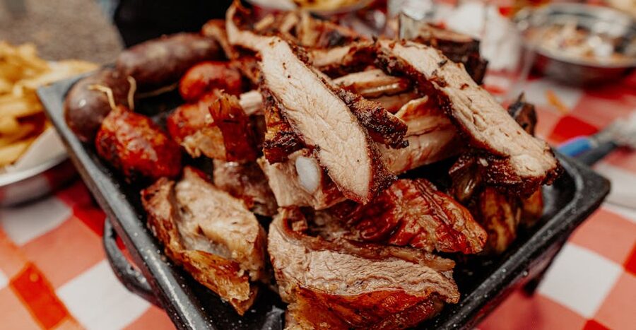 A platter of grilled meats served with vegetables
