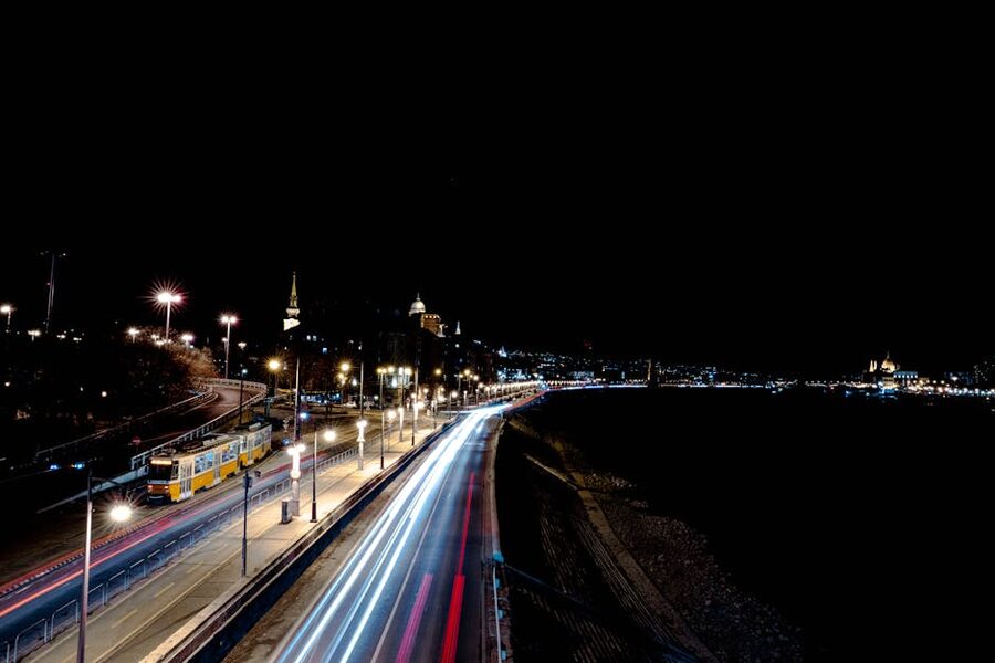 Long exposure of vehicles and tram lights on a Budapest street at night