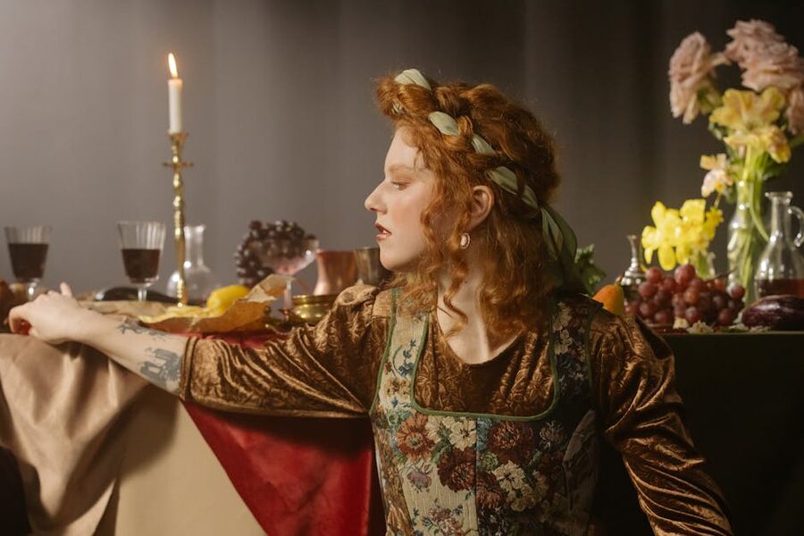 A woman in a vintage dress at a candlelit feast