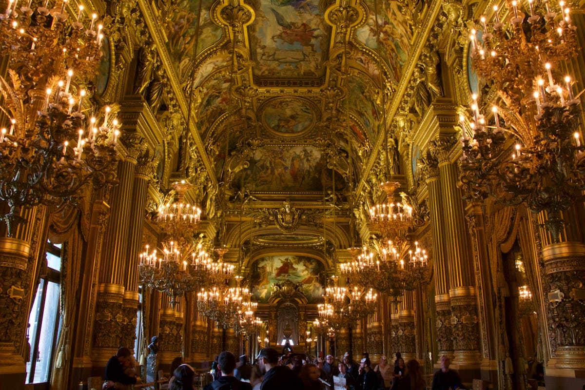 Majestic interior of the Palais Garnier with chandeliers and ornate ceiling