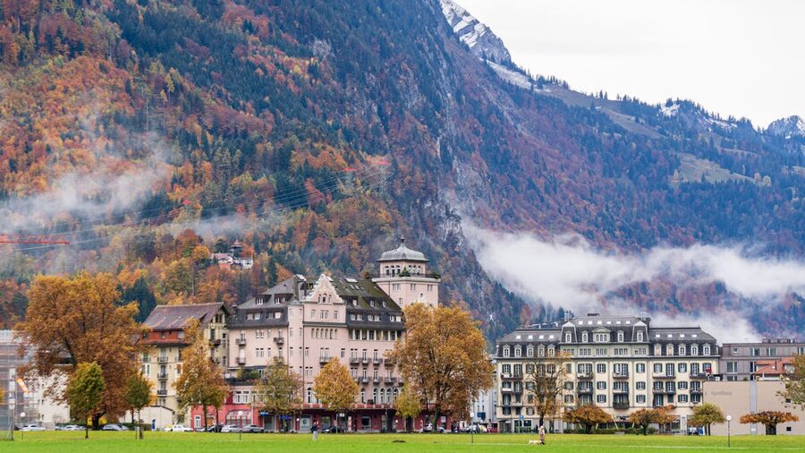 Autumn landscape of Interlaken town with mountains and historic buildings in Switzerland