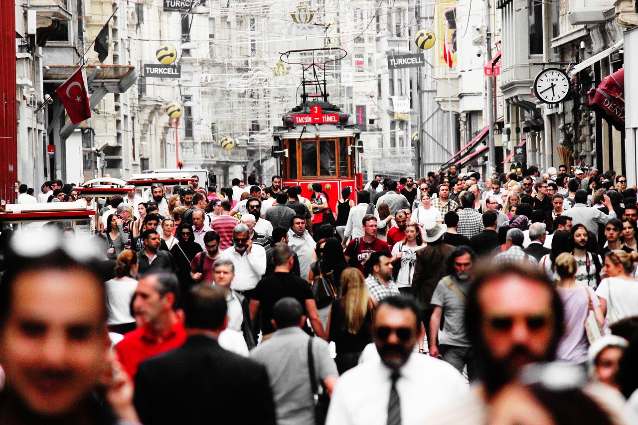 Red historic tram on crowded Istiklal Street in Istanbul