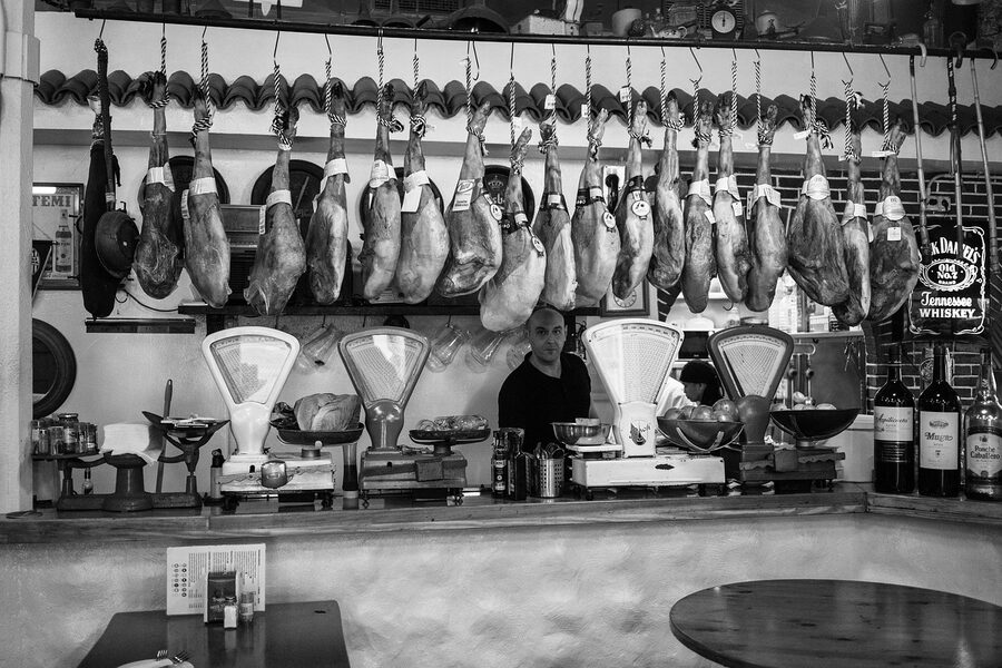 Jamon iberico hanging at a Spanish market stall