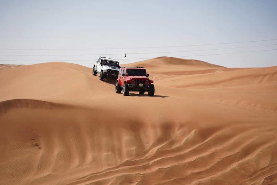 Jeeps driving through desert terrain on an offroad tour