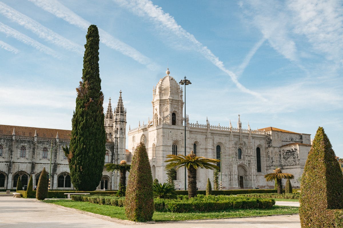 Jeronimos Monastery viewed through its gardens with clear blue sky