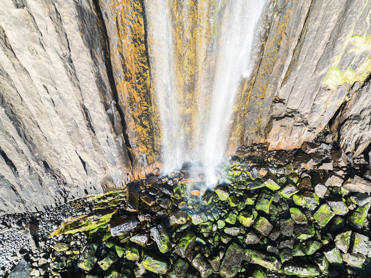 Kilt Rock sea cliffs with columnar basalt and waterfall on the Isle of Skye