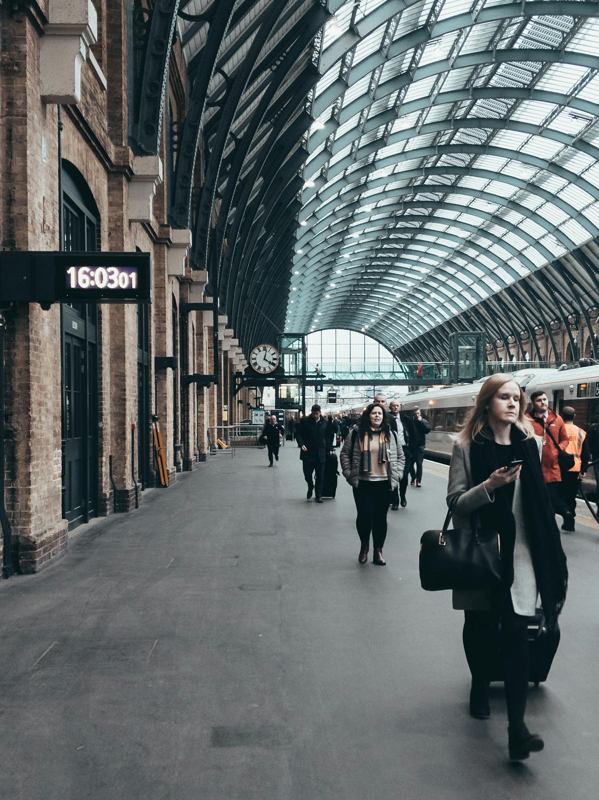 Commuters walking through the vast concourse of King's Cross station