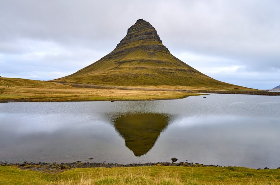 Kirkjufell mountain reflected in serene river