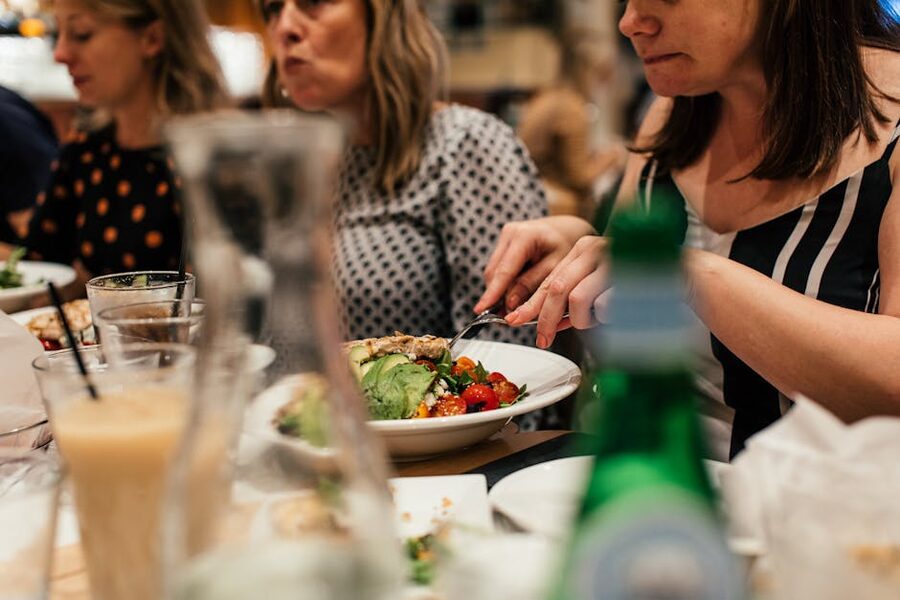 Friends sharing a meal around a restaurant table