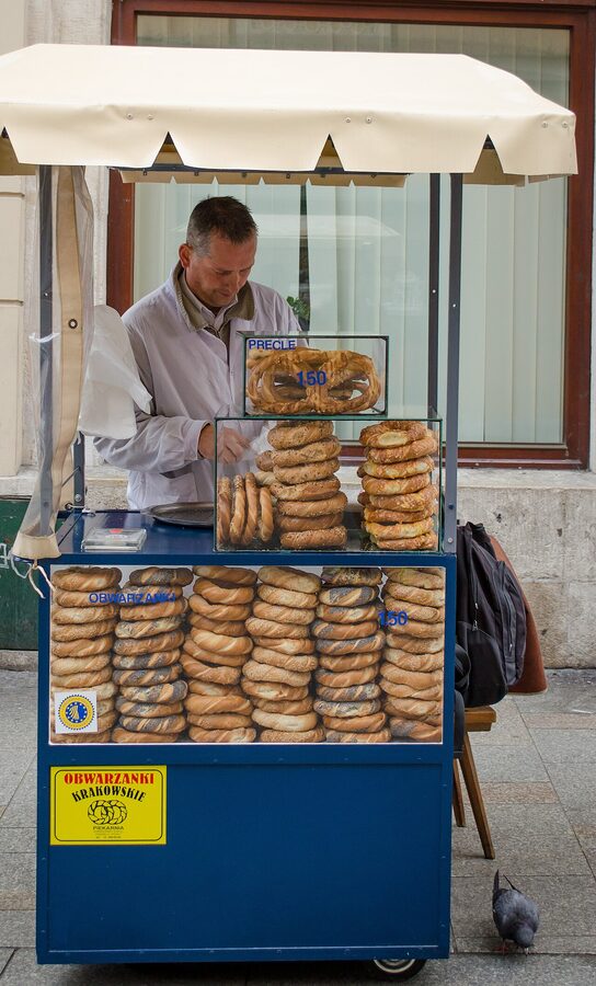 Obwarzanki cart vendor selling braided bread rings on a Krakow street