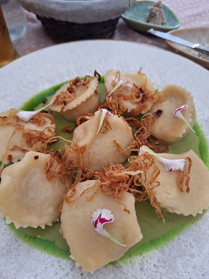 Polish pierogi dumplings plated with sour cream