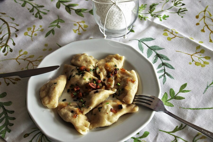 Plated Polish pierogi ready to eat with a fork
