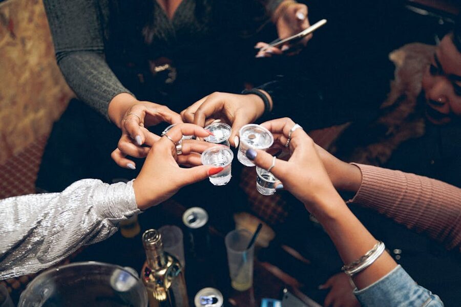 People toasting with shot glasses at a Krakow bar