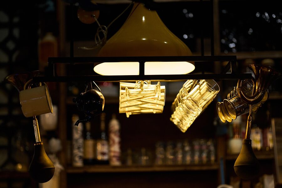 Beer glasses on a Krakow pub counter with low warm lighting