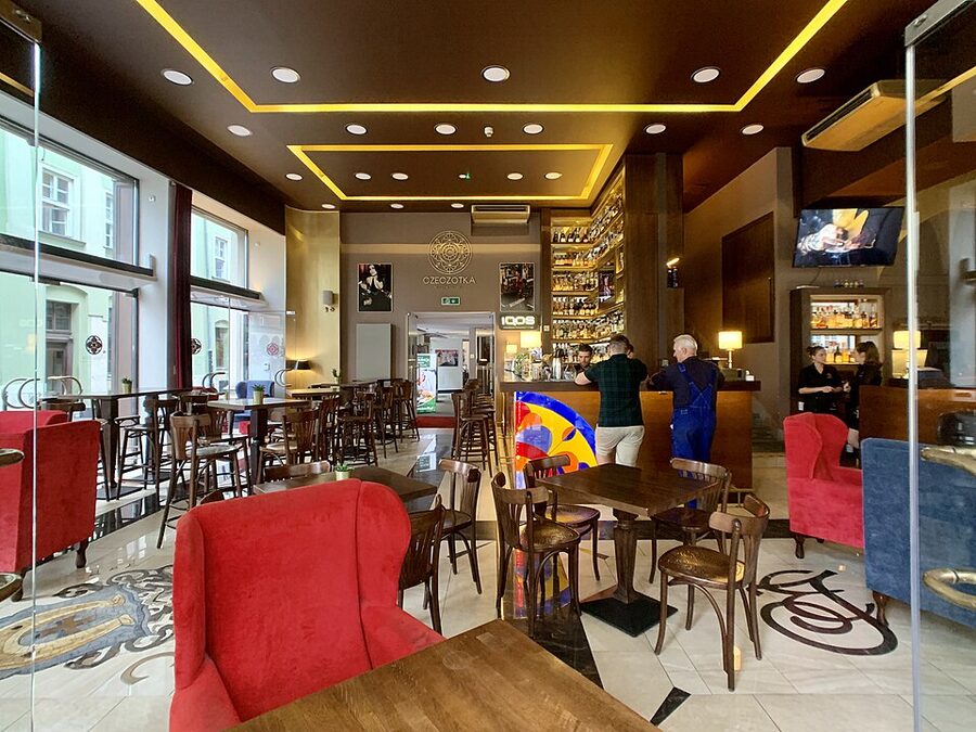 Czeczotka Cocktail Bar interior with green walls and bottles in Krakow