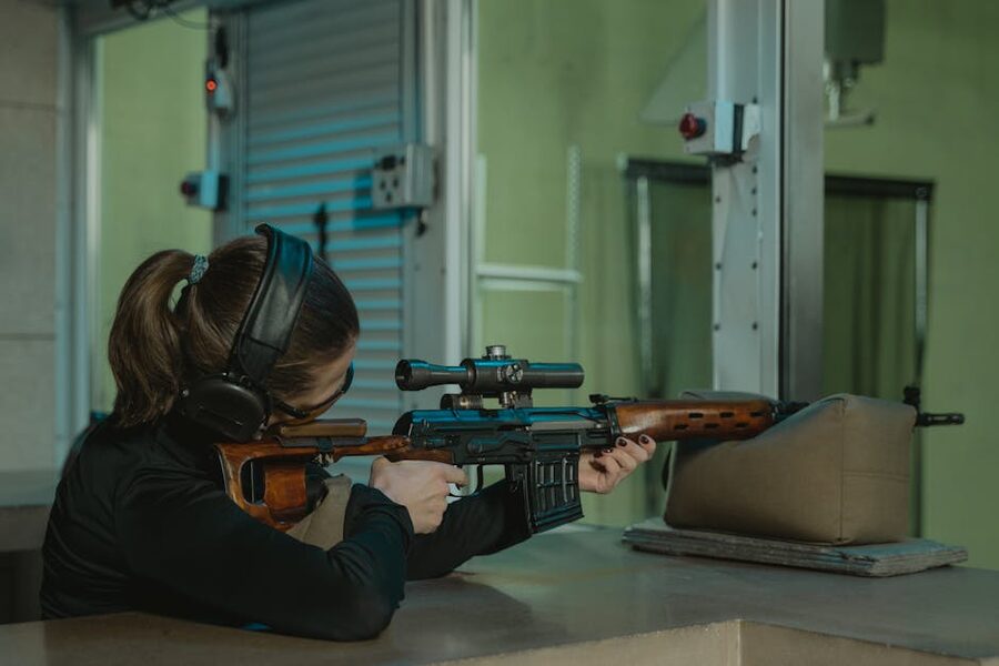 Sniper rifle aim at an indoor shooting range with full hearing protection