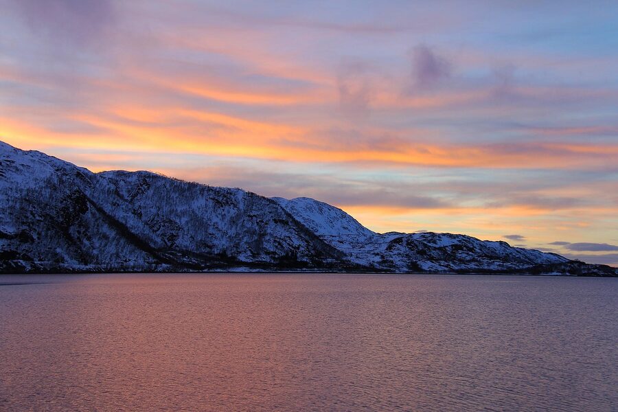 Kvaloya fjord sunset with orange sky near Tromso